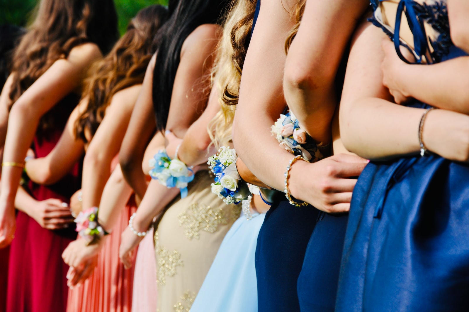 woman in blue sleeveless dress wearing blue and white floral tiara